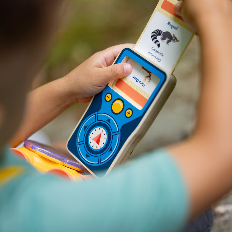 A kid playing with The Melissa & Doug Grand Canyon National Park Hiking Gear Play Set with Photo Disk Viewer