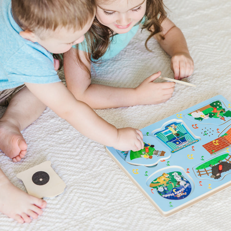 A kid playing with The Melissa & Doug Nursery Rhymes 1 Sound Puzzle - 6 PIeces