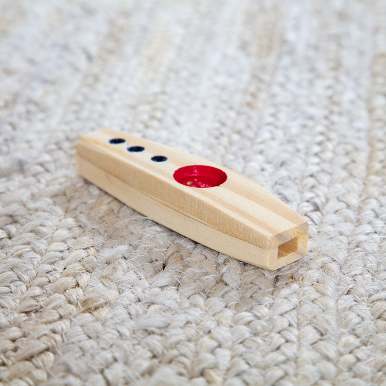 A playroom scene with The Melissa & Doug Makin' Music Beginner Wooden Kazoo