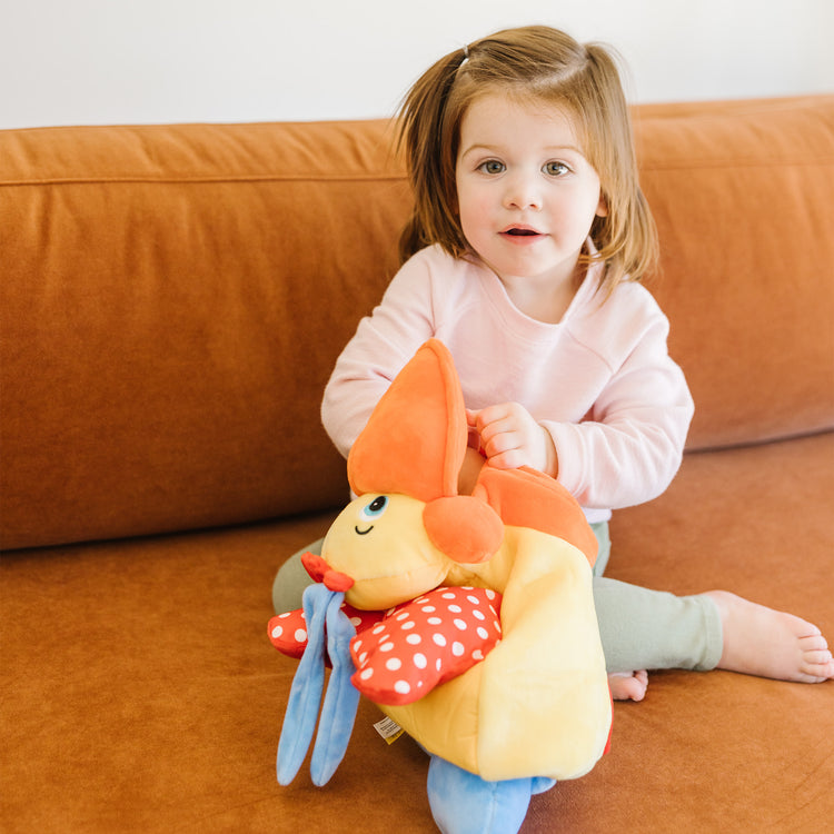 A kid playing with The Melissa & Doug K's Kids Hungry Pelican Soft Baby Educational Toy