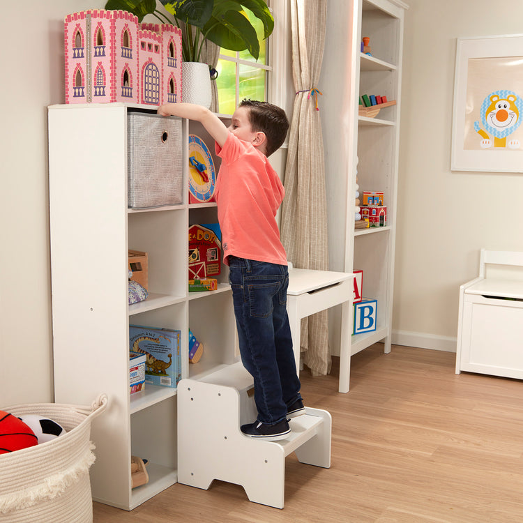 A kid playing with The Melissa & Doug Kids Wooden Step Stool - White