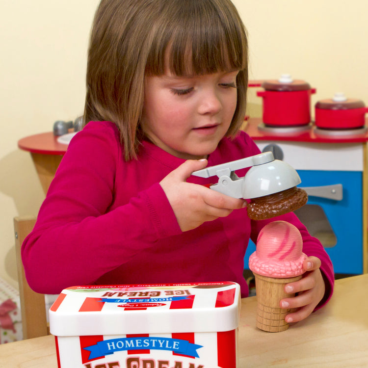 A kid playing with The Melissa & Doug Scoop and Stack Ice Cream Cone Magnetic Pretend Play Set, Multicolor