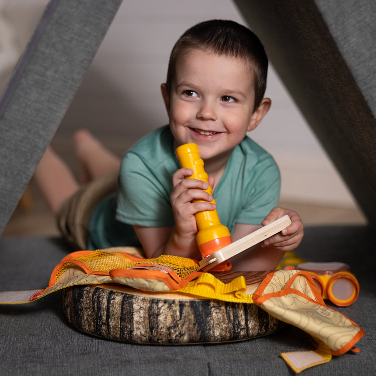 A kid playing with The Melissa & Doug Grand Canyon National Park Hiking Gear Play Set with Photo Disk Viewer