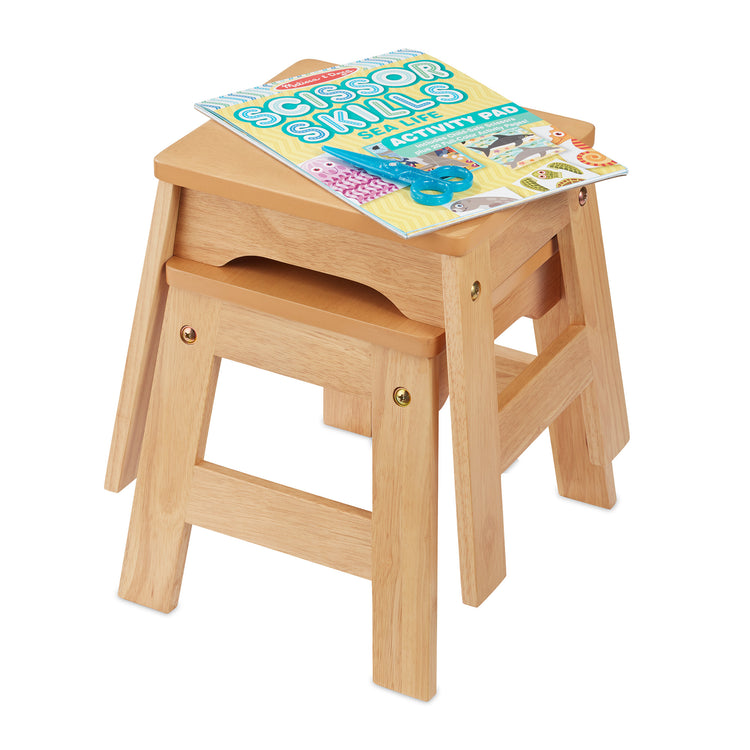 The loose pieces of The Melissa & Doug Wooden Stools – Set of 2 Stackable, Portable 11-Inch-Tall Stools (Natural)