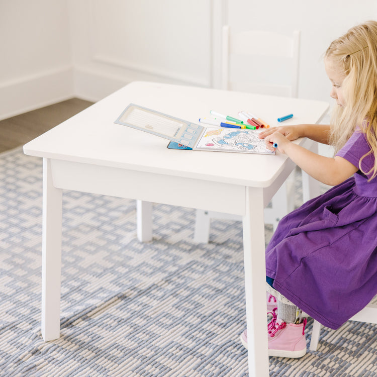 A kid playing with The Melissa & Doug Wooden Square Table (White)