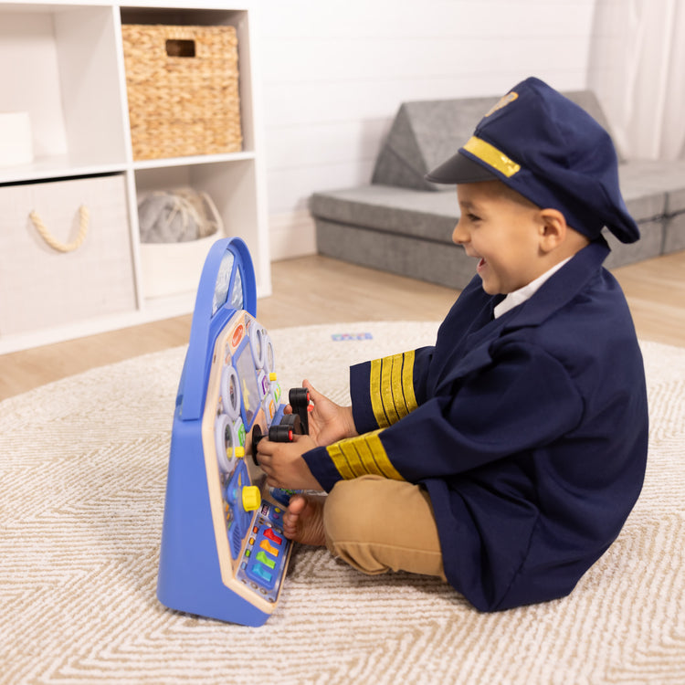 A kid playing with The Melissa & Doug Jet Pilot Interactive Dashboard Wooden Toy for Boys and Girls Ages 3+