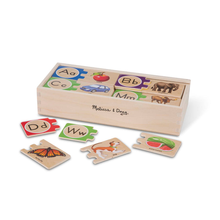 The loose pieces of The Melissa & Doug Self-Correcting Alphabet Wooden Puzzles With Storage Box (52 pcs)