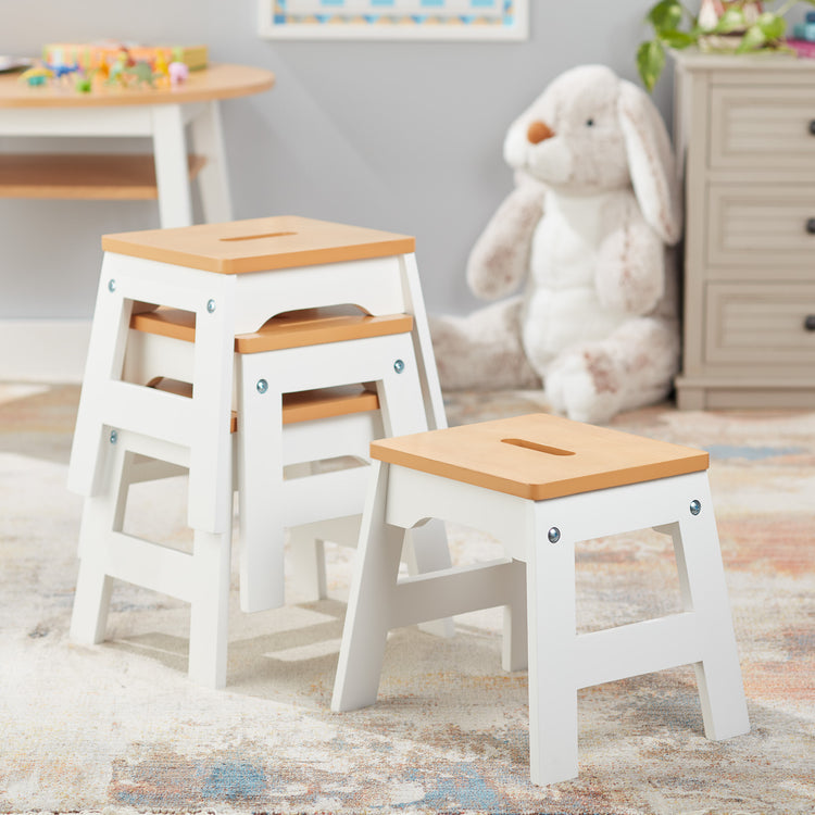 A playroom scene with The Melissa & Doug Wooden Stools – Set of 4 Stackable, Portable 11-Inch-Tall Stools (Natural/White)