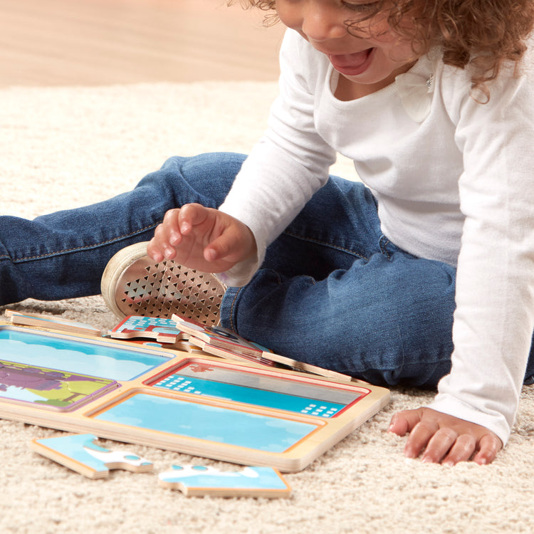 A kid playing with The Melissa & Doug Natural Play Wooden Puzzle: Ready, Set, Go (Four 4-Piece Vehicle Puzzles)