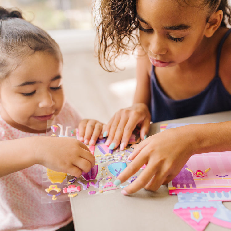 A kid playing with The Melissa & Doug Puffy Sticker Set: Princess - 67 Reusable Stickers