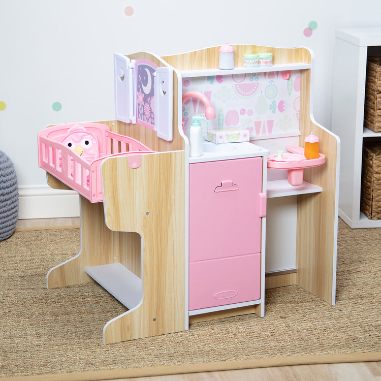 A playroom scene with The Melissa & Doug Baby Care Center and Accessory Sets