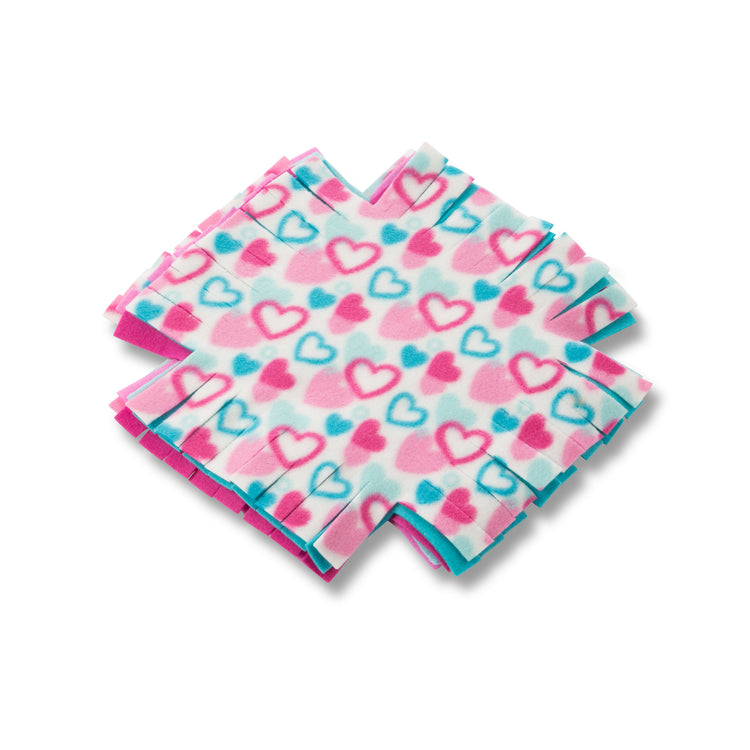 The loose pieces of The Melissa & Doug Created by Me! Heart Fleece Blanket No-Sew Craft Kit (40 squares, 3.5 feet x 5 feet)