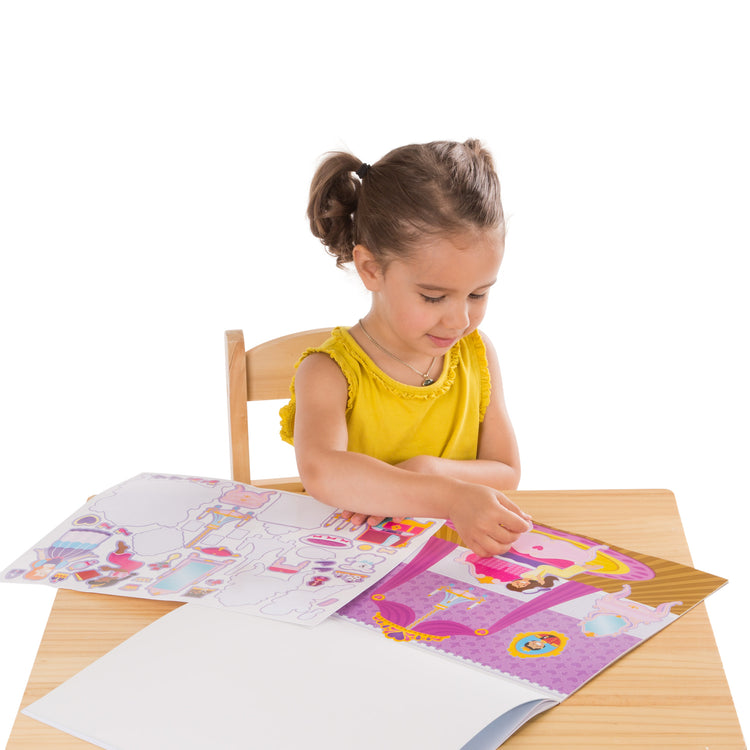 A child on white background with The Melissa & Doug Reusable Sticker Pad: Princess Castle - 200+ Stickers and 5 Scenes