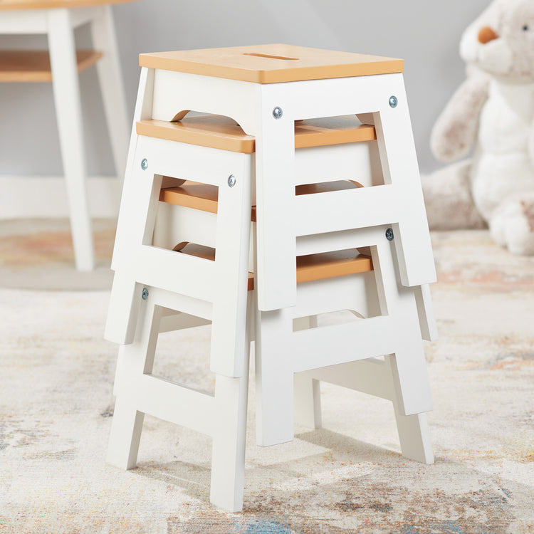 A playroom scene with The Melissa & Doug Wooden Stools – Set of 4 Stackable, Portable 11-Inch-Tall Stools (Natural/White)