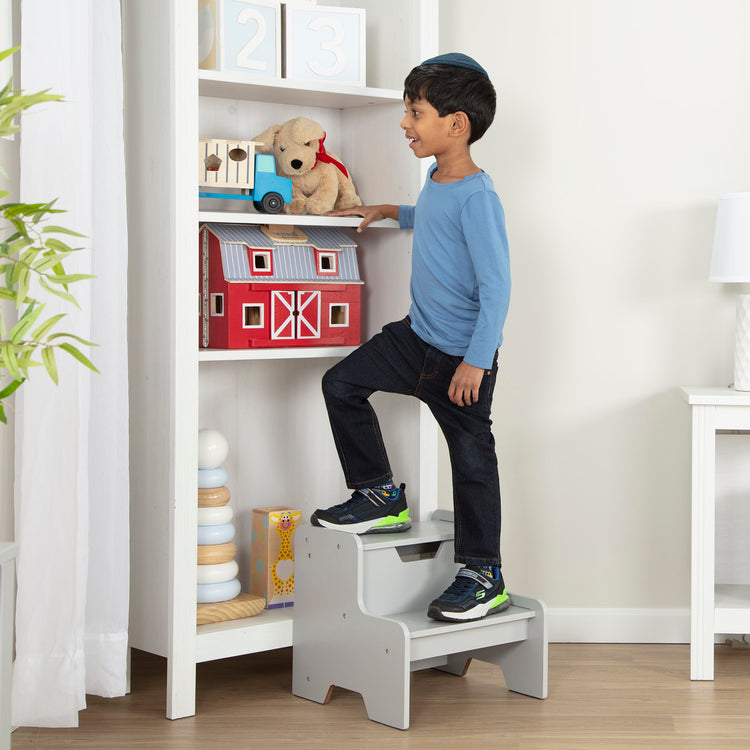 A kid playing with The Melissa & Doug Kids Furniture Wooden Step Stool - Gray