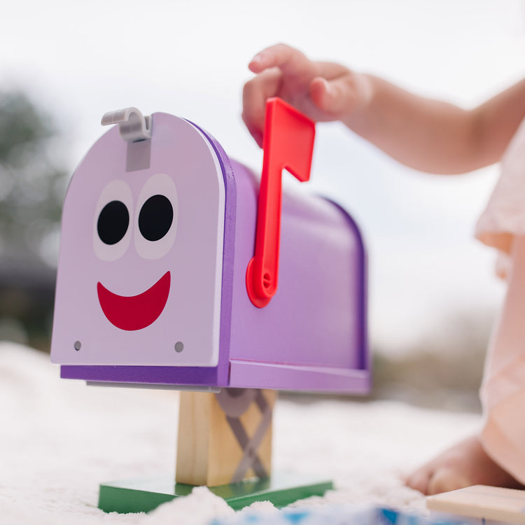 A kid playing with The Melissa & Doug Blue's Clues & You! Wooden Mailbox Play Set (27 Pieces)