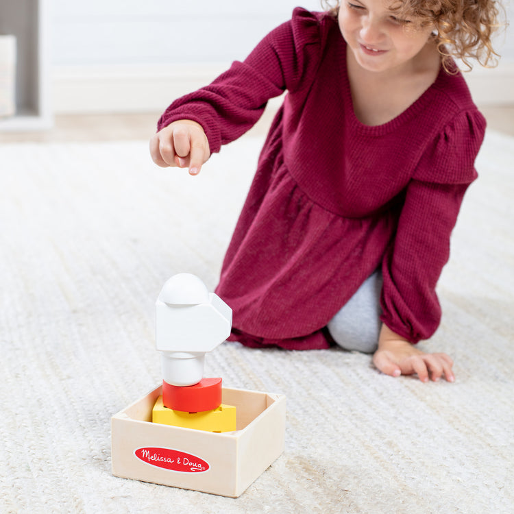 A kid playing with The Melissa & Doug Wooden Food Groups Play Food Set – Dairy