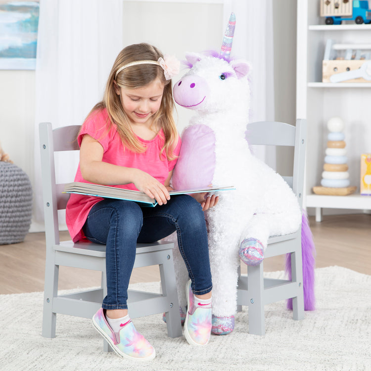 A kid playing with The Melissa & Doug Kids Furniture Wooden Chair Pair - Gray