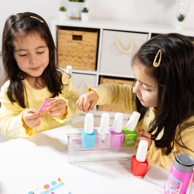 A kid playing with The Melissa & Doug Love Your Look Pretend Nail Care Play Set – 22 Pieces for Mess-Free Play Mani-Pedis (DOES NOT CONTAIN REAL COSMETICS)