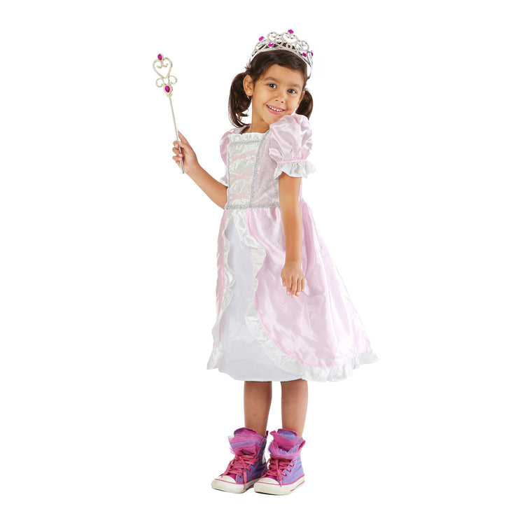 A child on white background with The Melissa & Doug Princess Role Play Costume Set (3 pcs)- Pink Gown, Tiara, Wand