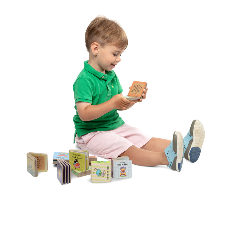 A child on white background with The Melissa & Doug Children's Book - Natural Play Book Tower: Little Nursery Books