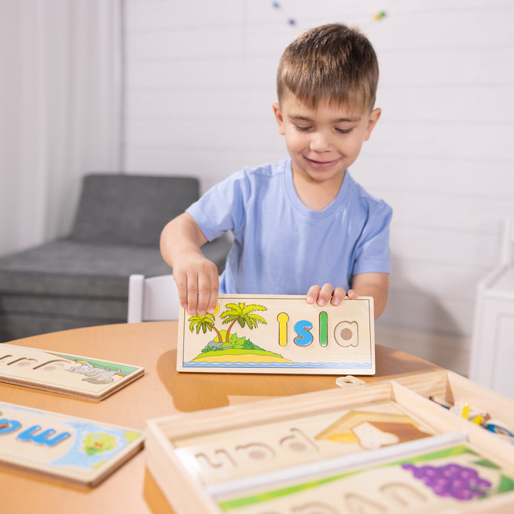 A kid playing with The Melissa & Doug Spanish See & Spell Educational Language Learning Toy