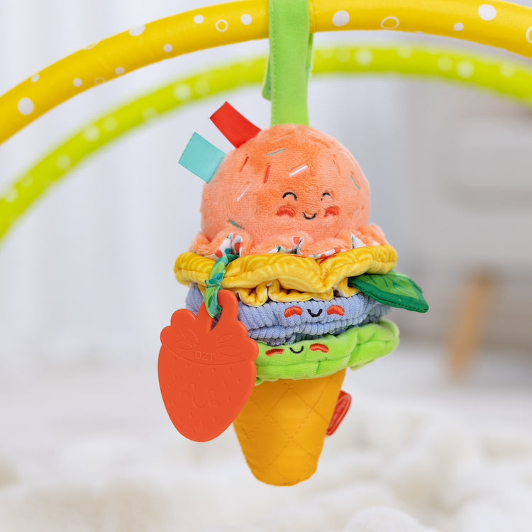 A playroom scene with The Melissa & Doug Ice Cream Take-Along Clip-On Infant Toy with Sound and Vibration