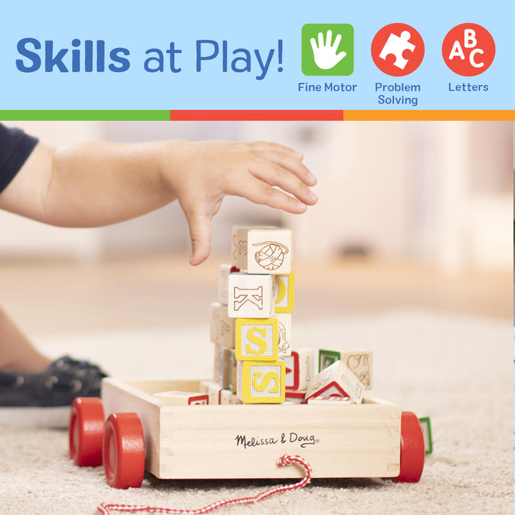 A kid playing with The Melissa & Doug Classic ABC Wooden Block Cart Educational Toy With 30 1-Inch Solid Wood Blocks