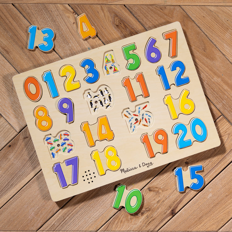 A playroom scene with The Melissa & Doug Numbers Sound Puzzle - Wooden Counting Puzzle With Sound Effects (21 pcs)