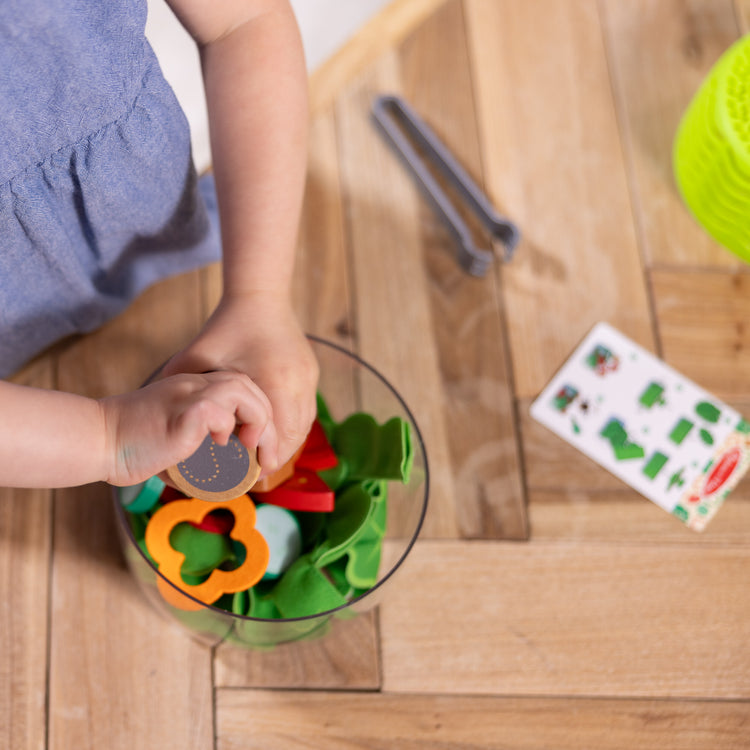 A kid playing with The Melissa & Doug Salad Spinner Play Set, Pretend Play Food for Boys and Girls Ages 3+