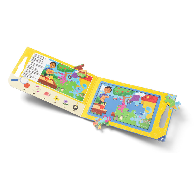 The loose pieces of The Melissa & Doug Blue's Clues & You! Take-Along Magnetic Jigsaw Puzzles (2 15-Piece Puzzles)