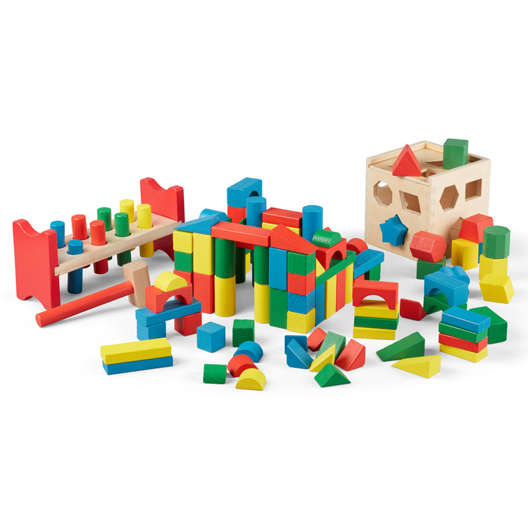 The loose pieces of The Melissa & Doug Stack, Sort & Pound Wooden Toy Collection (Building Blocks, Shape Sorter, Pounding Bench)