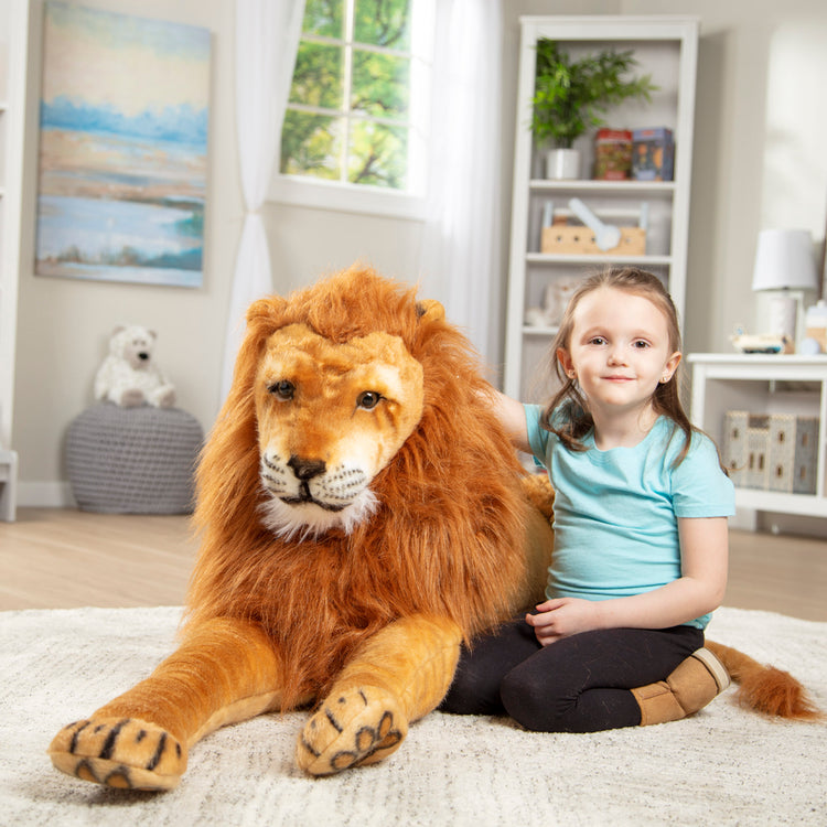 A kid playing with The Melissa & Doug Giant Lion - Lifelike Stuffed Animal (over 6 feet long)