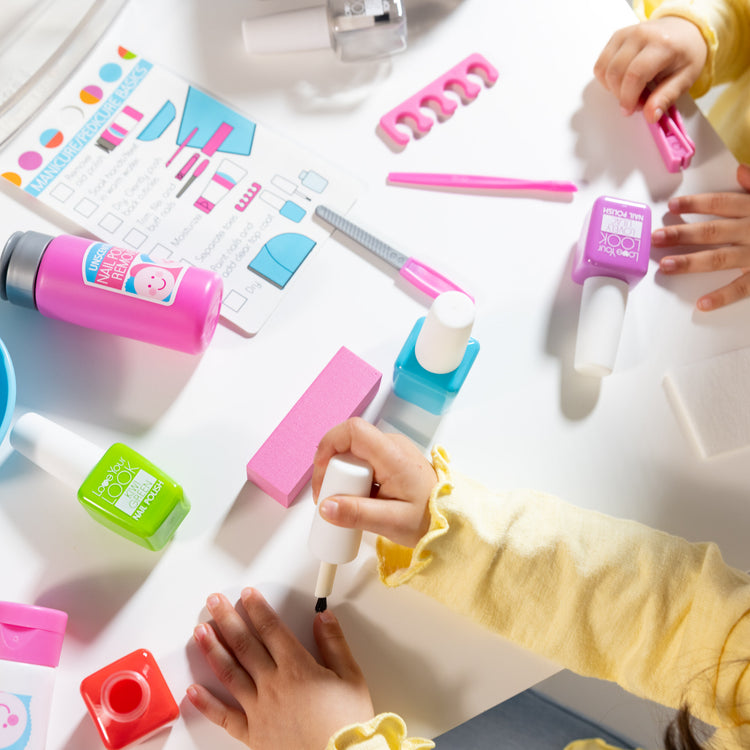 A kid playing with The Melissa & Doug Love Your Look Pretend Nail Care Play Set – 22 Pieces for Mess-Free Play Mani-Pedis (DOES NOT CONTAIN REAL COSMETICS)