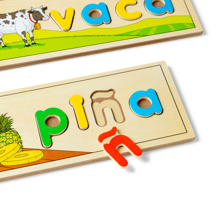 A kid playing with The Melissa & Doug Spanish See & Spell Educational Language Learning Toy