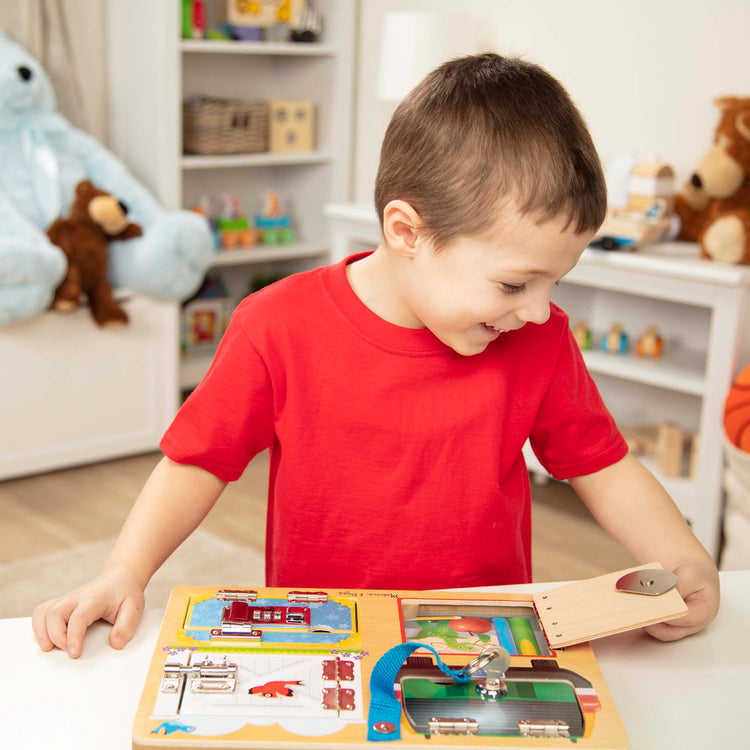 A kid playing with The Melissa & Doug Locks and Latches Board Wooden Educational Toy