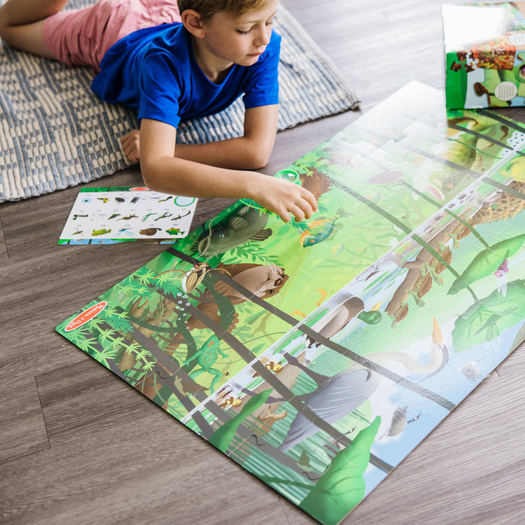 A kid playing with The Melissa & Doug Double-Sided Seek & Find Puzzle