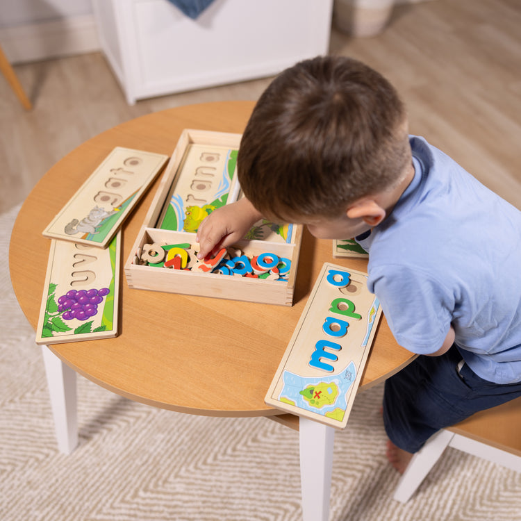 A kid playing with The Melissa & Doug Spanish See & Spell Educational Language Learning Toy