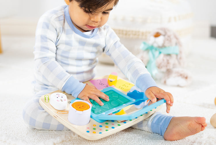 toddler playing with wooden workspace toy