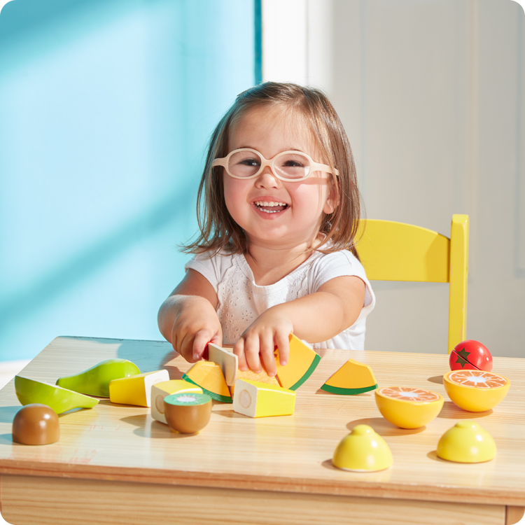 child playing with play food toy