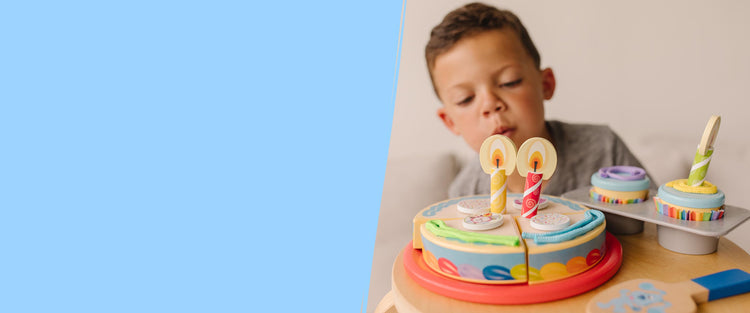 child playing with birthday cake toy