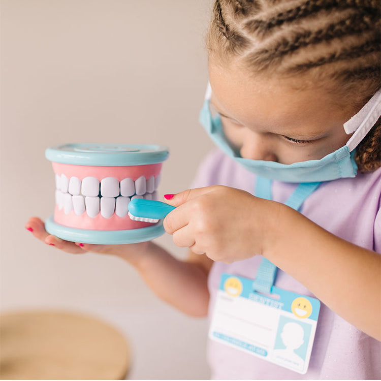 child playing with dentist set