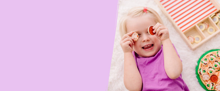 child playing with play food toy