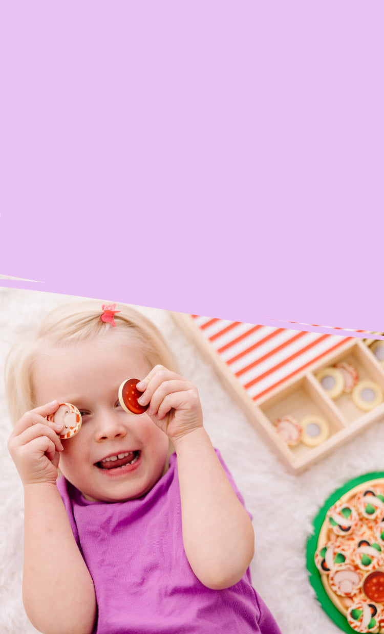 child playing with play food toy