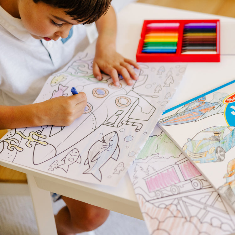 A kid playing with The Melissa & Doug Jumbo Coloring Pad: Vehicles - 50 Pages of White Bond Paper (11 x 14 inches)