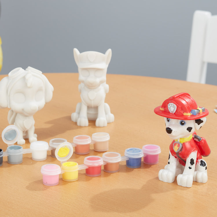 A playroom scene with The Melissa & Doug PAW Patrol Craft Kit - 3 Decorate Your Own Pup Figurines