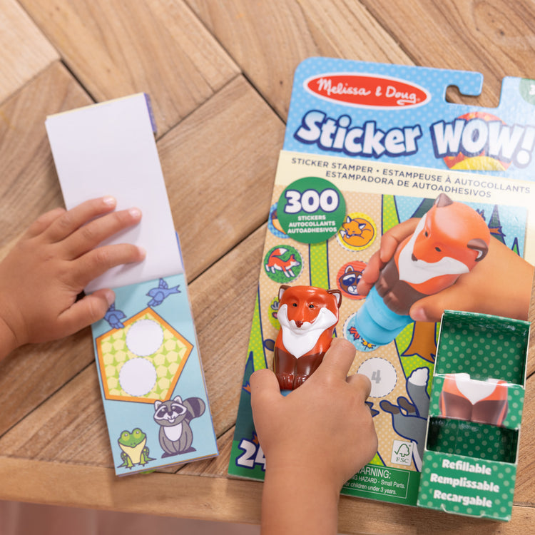 A kid playing with The Melissa & Doug Sticker WOW!™ Fox Bundle: 24-Page Activity Pad, Sticker Stamper, 500 Stickers, Arts and Crafts Fidget Toy Collectible Character