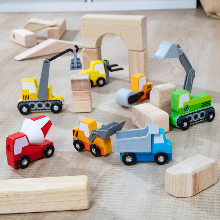 A playroom scene with The Melissa & Doug Wooden Construction Site Vehicles With Wooden Storage Tray (8 pcs)