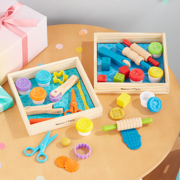 A playroom scene with The Melissa & Doug Clay Play Activity Set - With Sculpting Tools and 8 Tubs of Modeling Dough