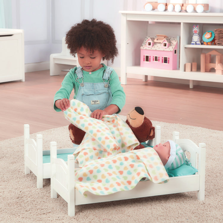 A kid playing with The Melissa & Doug Mine to Love Wooden Play Bunk Bed for Dolls, Stuffed Animals - White (2 Beds, 17.4”H x 9.1”W x 20.7”L Assembled and Stacked)